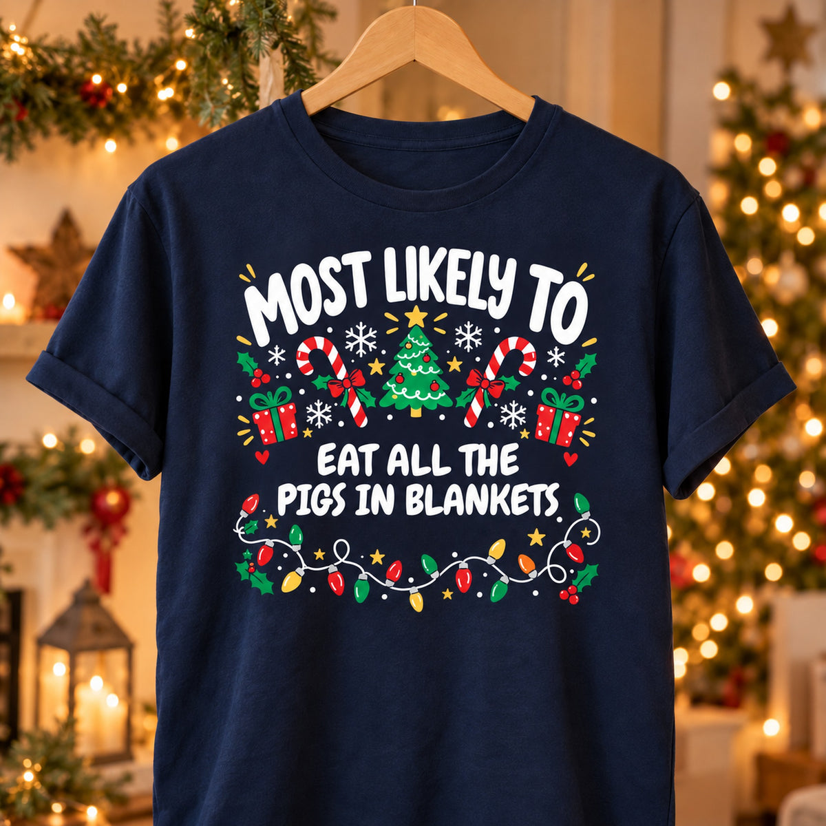 Navy personalised Most Likely To Eat All The Pigs In Blankets Christmas T-shirt on a hanger