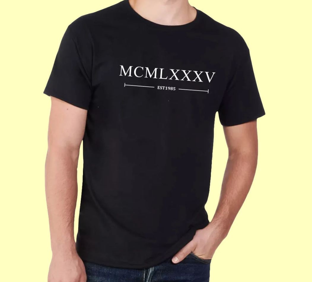 Our Customised Roman Numerals T-Shirt is a stylish way to celebrate a special birth year! Featuring elegant and timeless Roman numerals that represent the year of your choice—like MCMXCV for 1995—this shirt adds a personal touch to any wardrobe. Made from soft, high-quality cotton, it offers all-day comfort, making it perfect for casual outings, birthdays, or as a unique gift for friends and family. Whether you’re celebrating a milestone birthday or just want to showcase your birth year in a chic way, this 