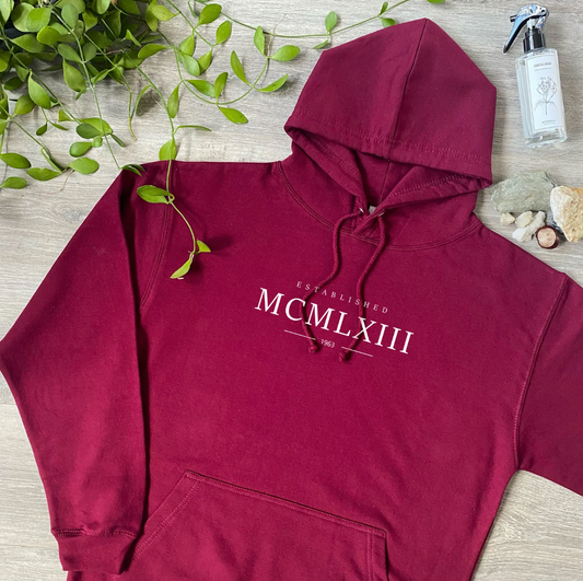 Our Hand-Printed Organic Cotton Hoodie with a Personalised Roman Numerals Date design offers a stylish and meaningful way to celebrate a special moment. Made from 100% soft, breathable organic cotton, this hoodie combines comfort with eco-friendly fashion. The hand-printed Roman numerals can be customised to feature a date that’s significant to you, making it a unique and personal piece. Perfect for casual wear or as a thoughtful gift, this hoodie brings timeless design and craftsmanship together, creating 
