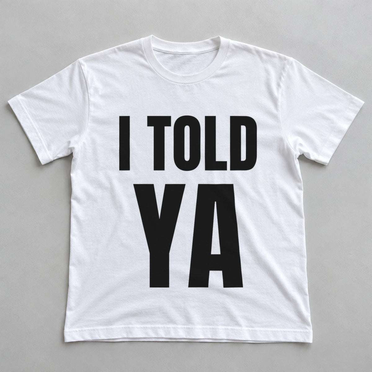 I Told Ya white t-shirt flat lay
