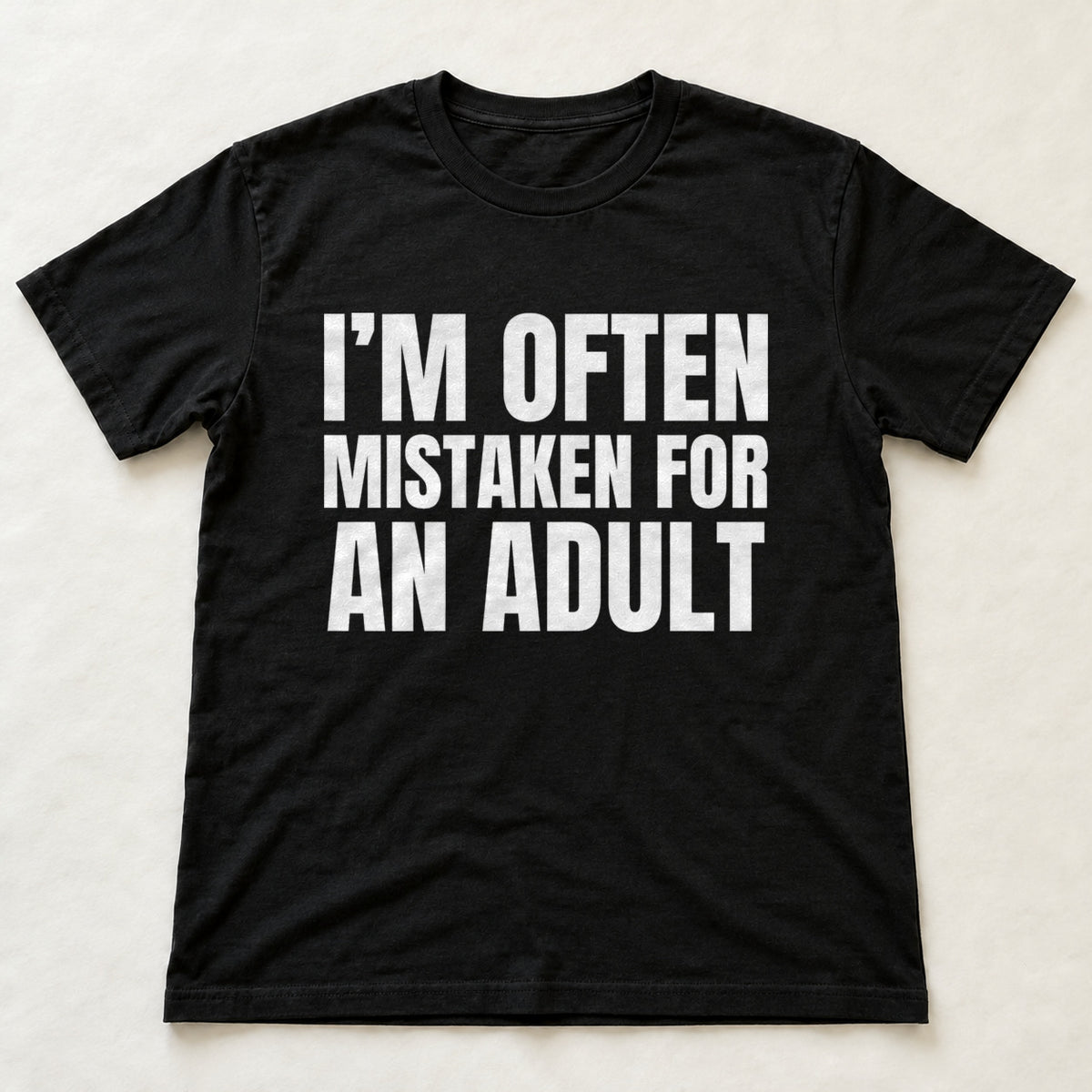 I'm Often Mistaken For An Adult black t-shirt flat lay